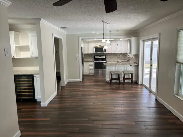 a kitchen with stainless steel appliances kitchen island granite countertop a stove and a refrigerator