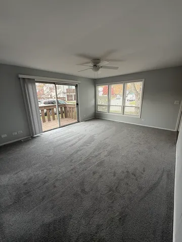 an empty room with a empty space and windows