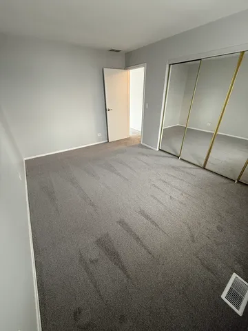 an empty room with a empty space and windows