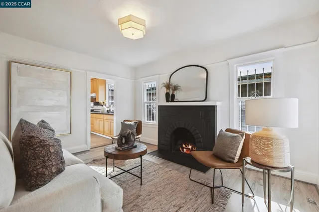 a living room with furniture a window and a fireplace