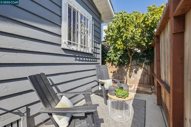 a view of a chairs and table in a balcony