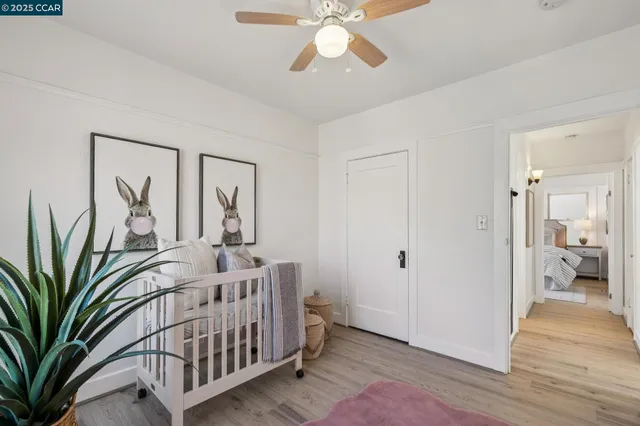a view of a hallway with workspace and wooden floor