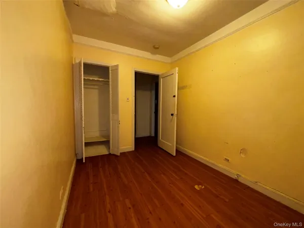 a view of a room with wooden floor and a wall