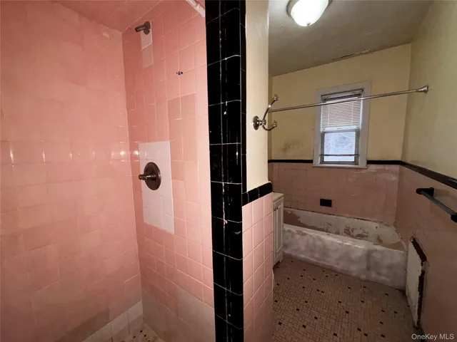 a bathroom with a bathtub and shower