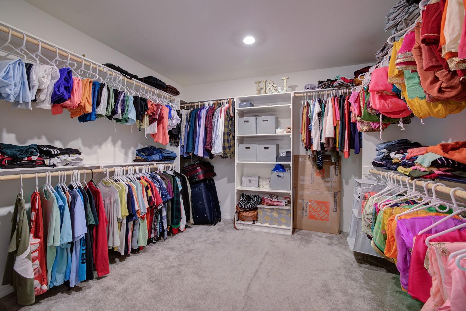26055 Plumcot Drive Corona, CA 92883 - Photo 13 of 47 a view of walk in closet with clothes