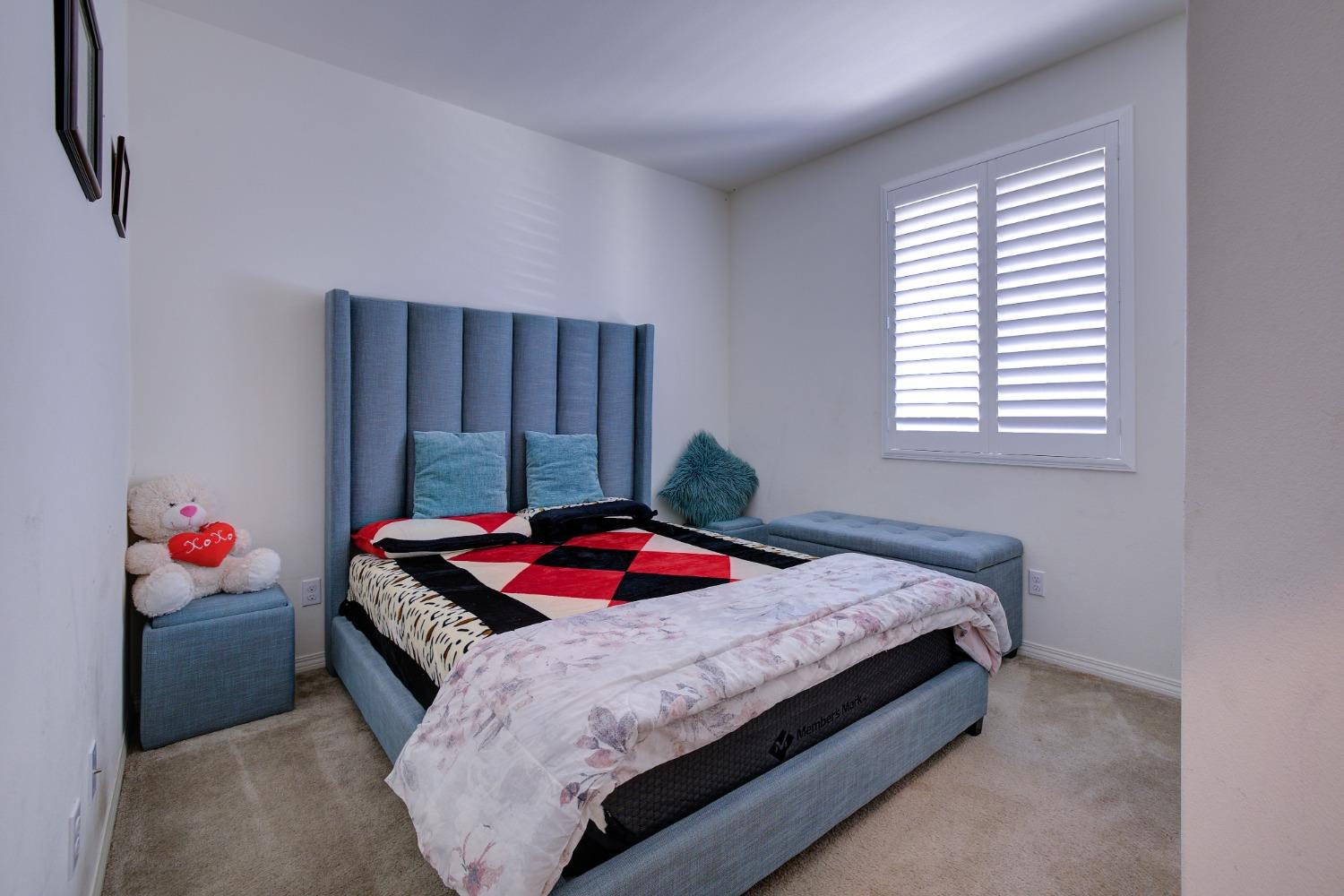 26055 Plumcot Drive Corona, CA 92883 - Photo 15 of 47 a bedroom with a bed and window