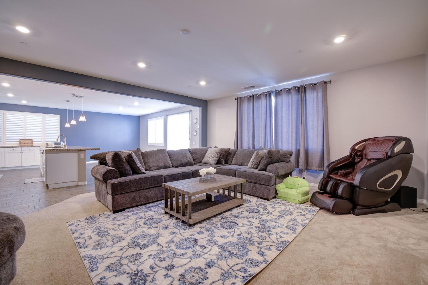 26055 Plumcot Drive Corona, CA 92883 - Photo 19 of 47 a living room with furniture a rug and gym equipment