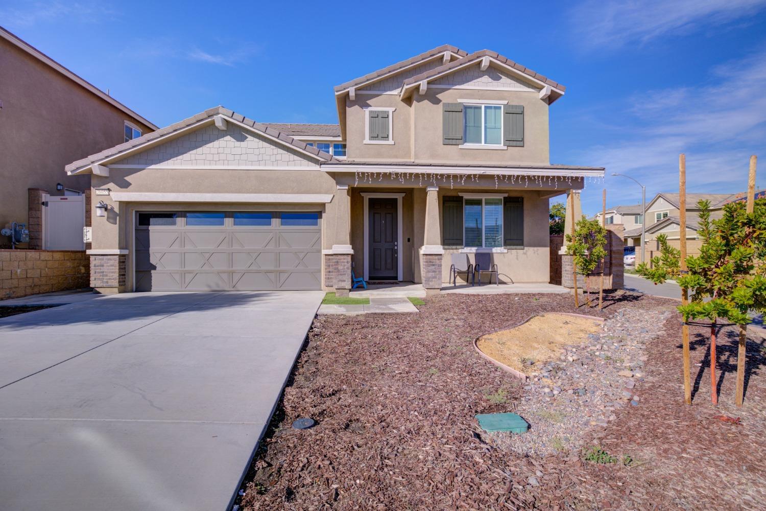 26055 Plumcot Drive Corona, CA 92883 - Photo 2 of 47 a front view of a house with a yard and garage