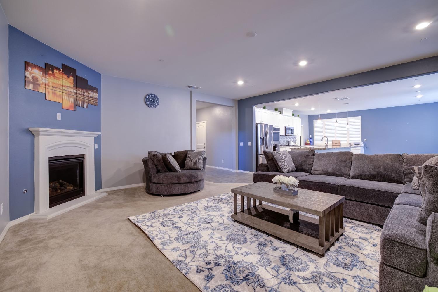 26055 Plumcot Drive Corona, CA 92883 - Photo 22 of 47 a living room with furniture fireplace and rug