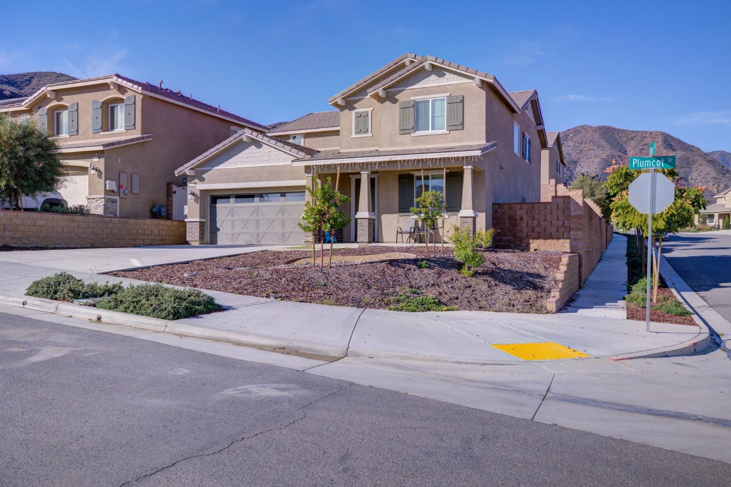 26055 Plumcot Drive Corona, CA 92883 - Photo 3 of 47 a front view of house with yard and outdoor seating
