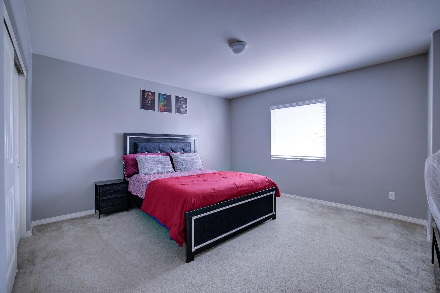 26055 Plumcot Drive Corona, CA 92883 - Photo 33 of 47 a spacious bedroom with a bed and a window