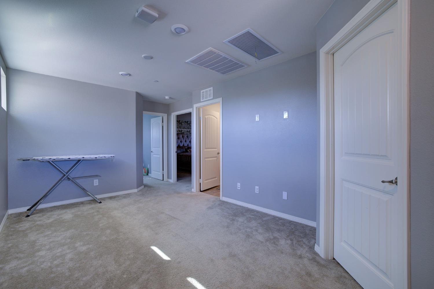 26055 Plumcot Drive Corona, CA 92883 - Photo 40 of 47 en empty room with closet and a chandelier fan