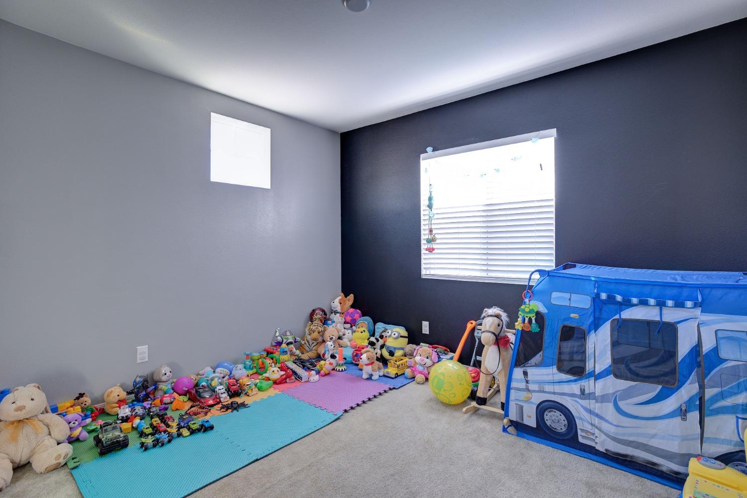 26055 Plumcot Drive Corona, CA 92883 - Photo 5 of 47 a room with toys and a window
