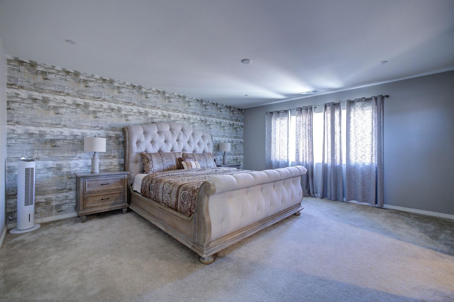 26055 Plumcot Drive Corona, CA 92883 - Photo 7 of 47 a bedroom with a bed and a ceiling fan