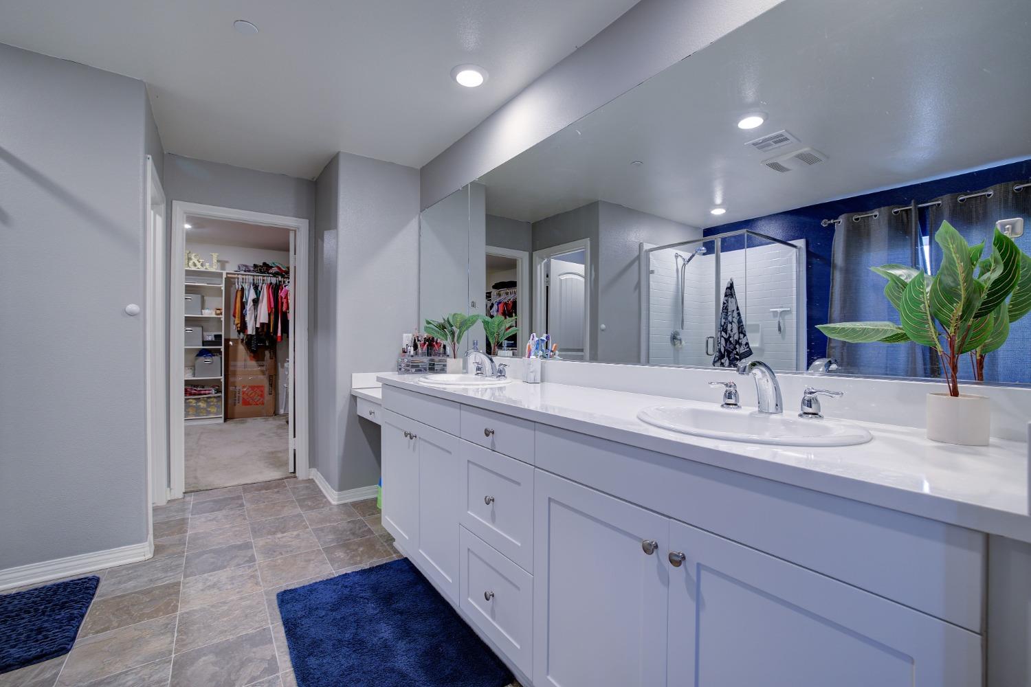 26055 Plumcot Drive Corona, CA 92883 - Photo 9 of 47 a spacious bathroom with a double vanity sink and a mirror