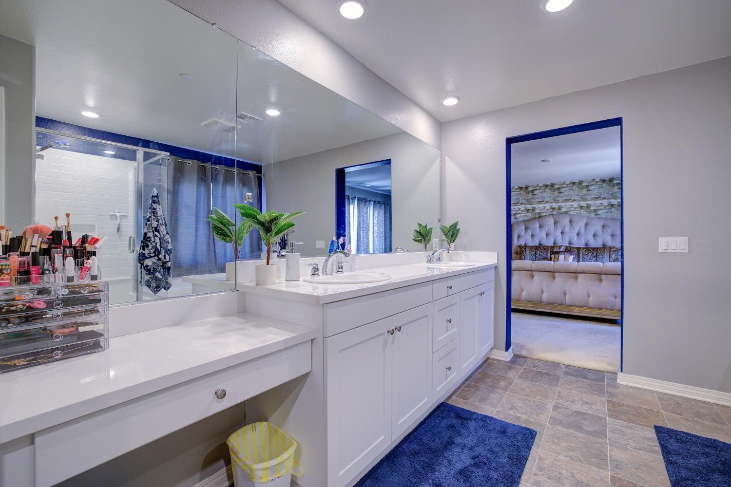 26055 Plumcot Drive Corona, CA 92883 - Photo 10 of 47 a bathroom with a double vanity sink mirror and next to a window