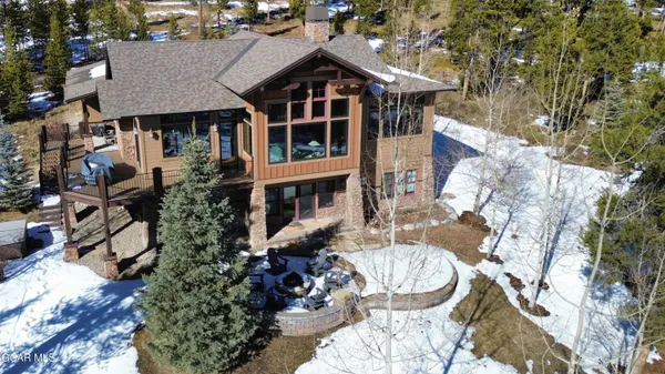 a aerial view of a house with table and chairs and potted plants