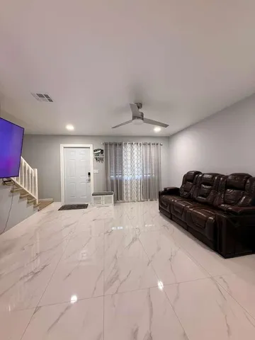 a large bedroom with a bed and a chandelier