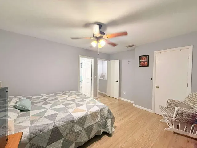 a bedroom with a bed and a chandelier