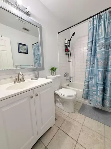 a bathroom with a double vanity sink toilet and shower