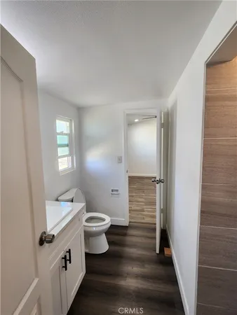 a view of a room with wooden floor