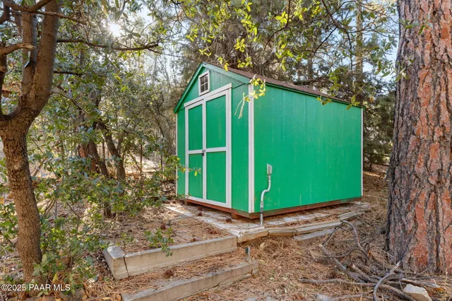 a green field with some trees in front of it