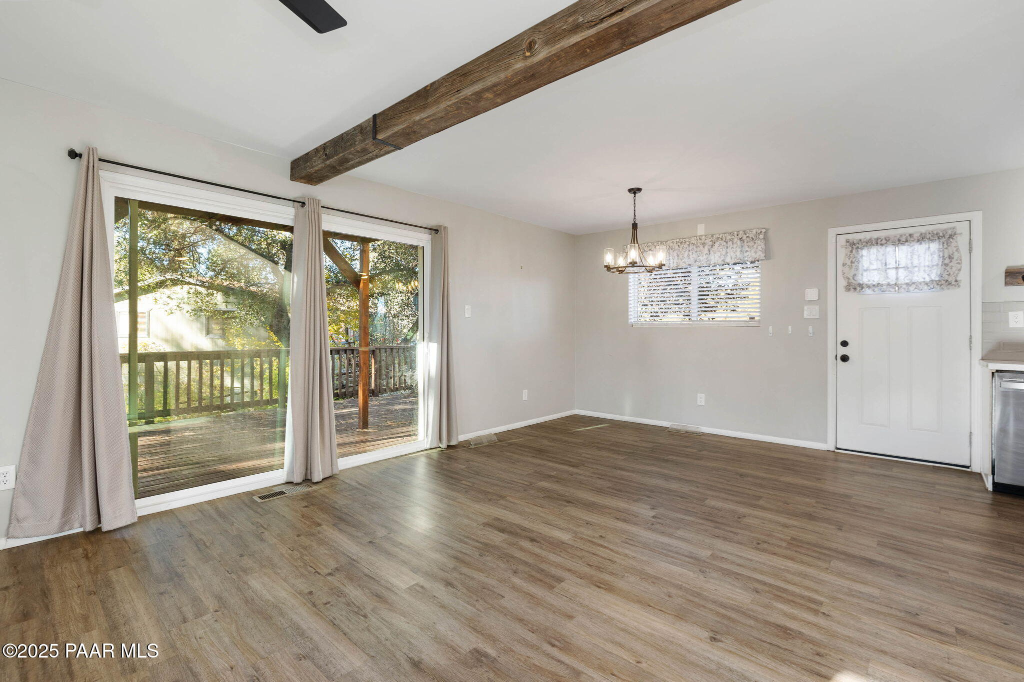 2079 Redwood Way Prescott, AZ 86303 - Photo 7 of 21 a view of an empty room with wooden floor and a window