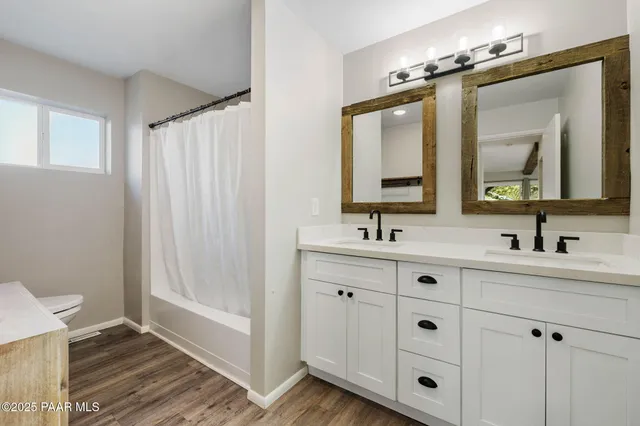a bathroom with double vanity sink and a mirror