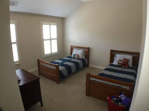 a bedroom with bed and window