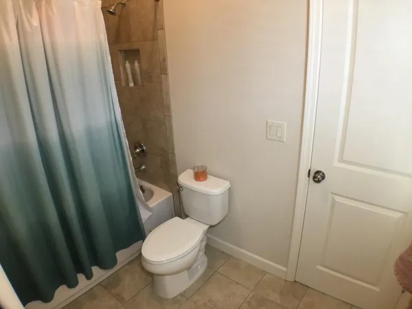 a white toilet sitting next to a sink