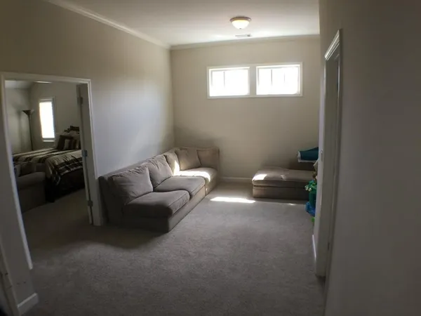 a living room with furniture and a bathroom