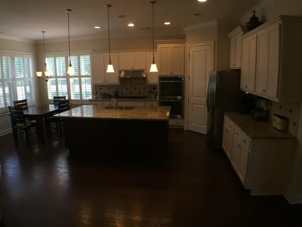 a kitchen with counter top space cabinets and appliances