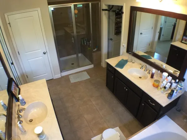 a bathroom with a double vanity sink a mirror and shower