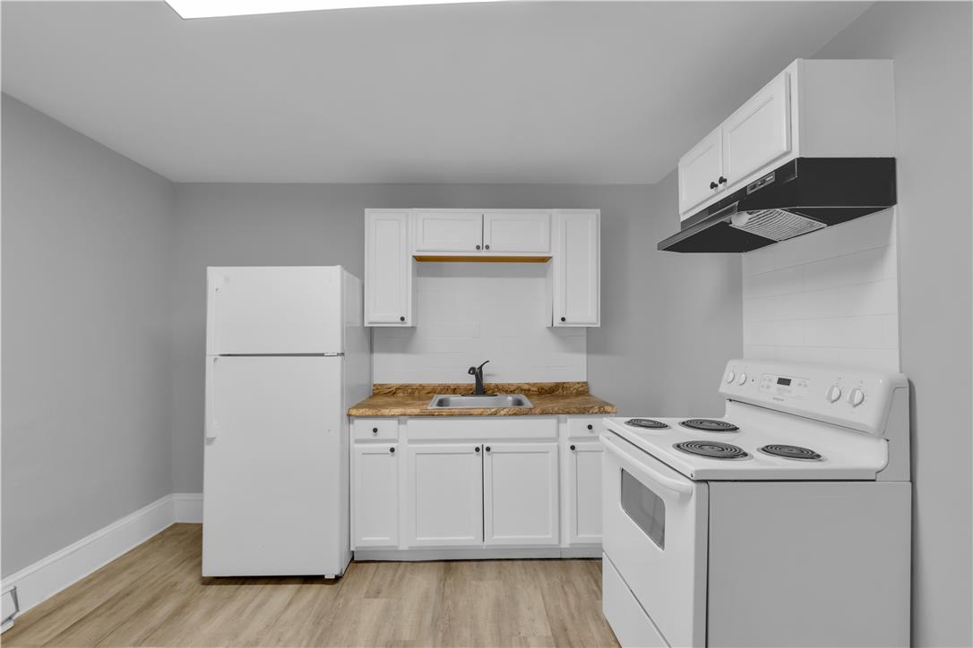 149 West Ridge Street, Unit 1B Lansford, PA 18232 - Photo 7 of 14 A compact kitchen offering all essential appliances for daily meal preparation.