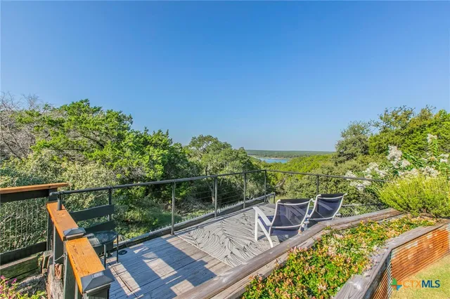 a view of a chair and tables in the balcony