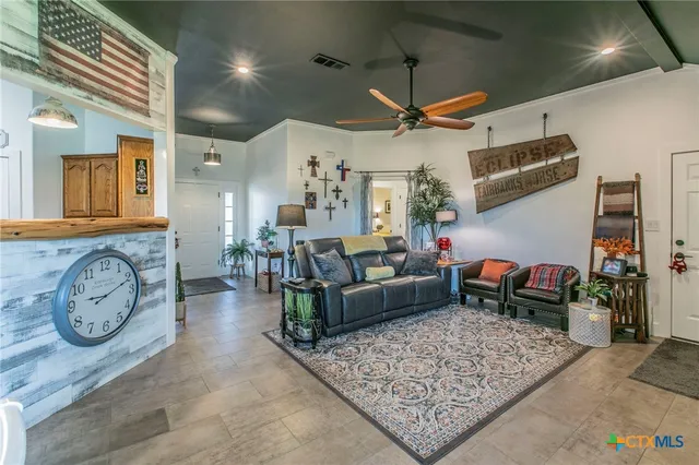 a living room with furniture a rug and a clock