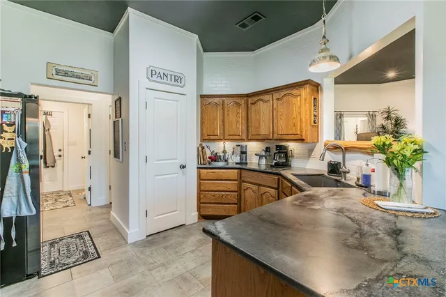 a kitchen with refrigerator and cabinets