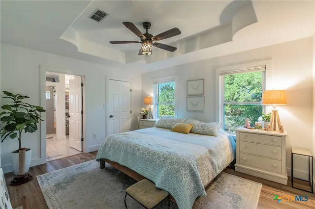 a bedroom with a bed and a potted plant
