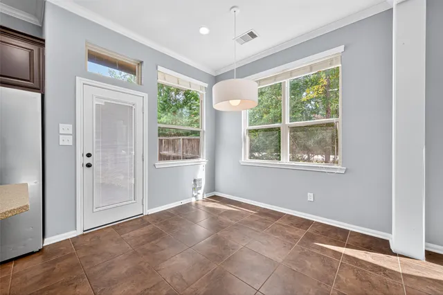 a view of an empty room with windows and closet