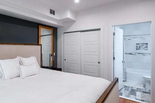 a bedroom with a bed and a view of bathroom