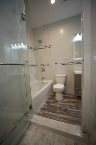 a bathroom with a toilet a sink and shower