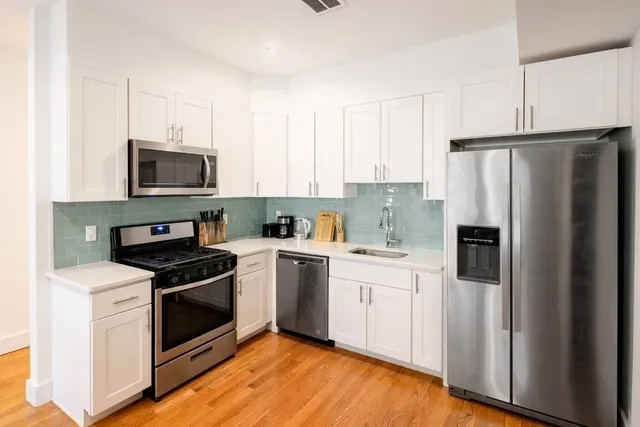 a kitchen with a sink stove and refrigerator