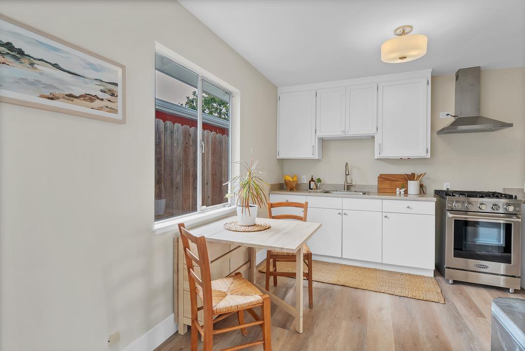 130 Hainline Road Aptos, CA 95003 - Photo 17 of 28 a kitchen with a dining table chairs and a stove top oven