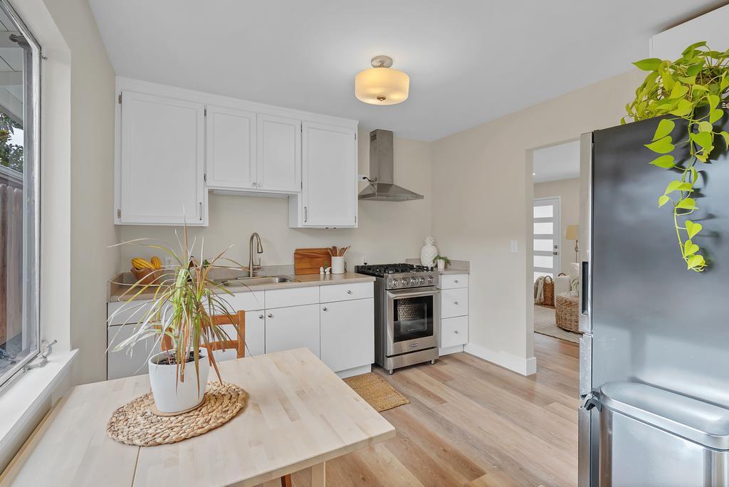 130 Hainline Road Aptos, CA 95003 - Photo 5 of 28 a kitchen with stainless steel appliances a white table chairs and a stove