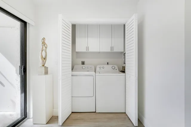 a bed sitting in a spacious bedroom next to a window
