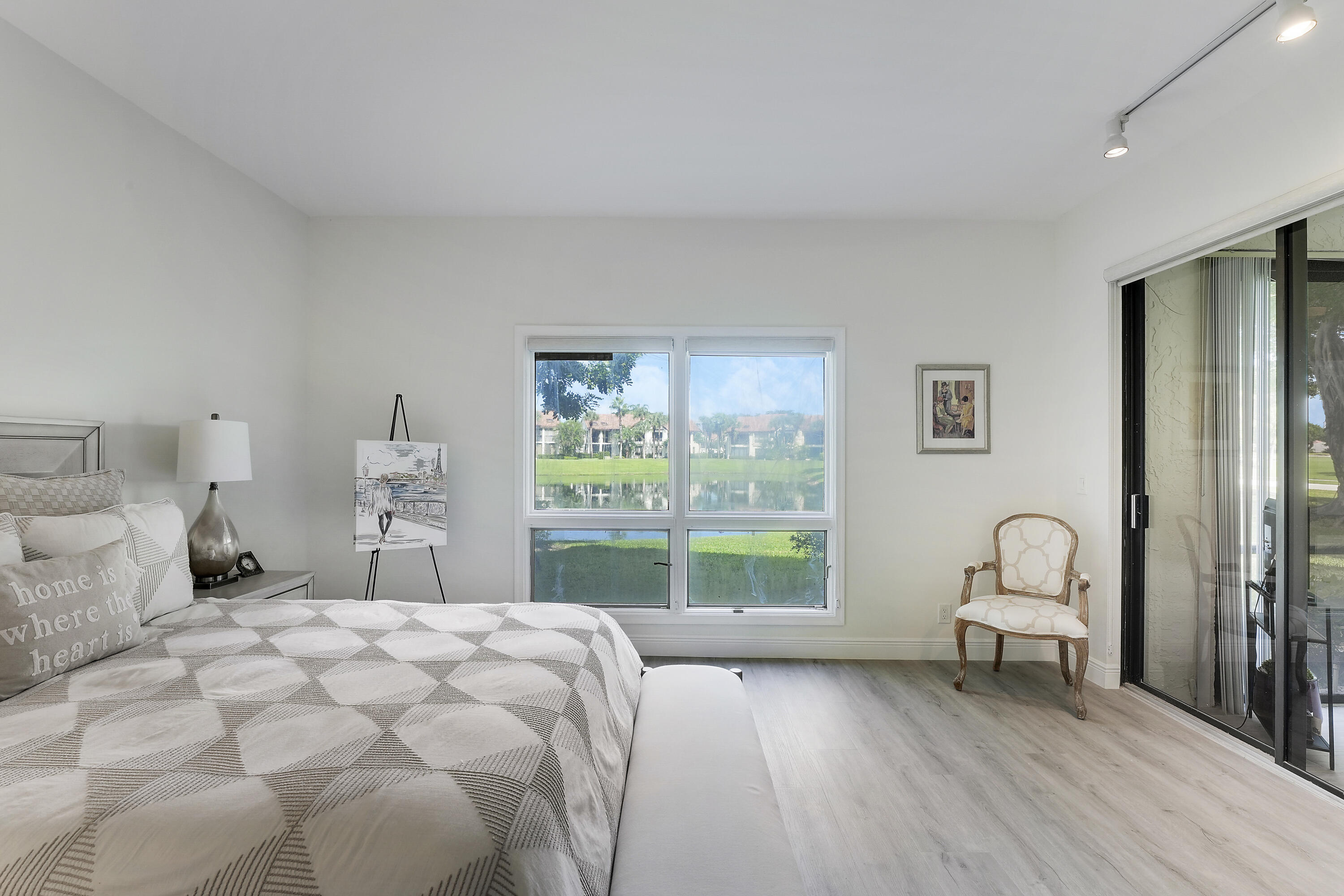 7860 Seville Place, Unit 2203 Boca Raton, FL 33433 - Photo 19 of 43 a bedroom with a bed and a large window