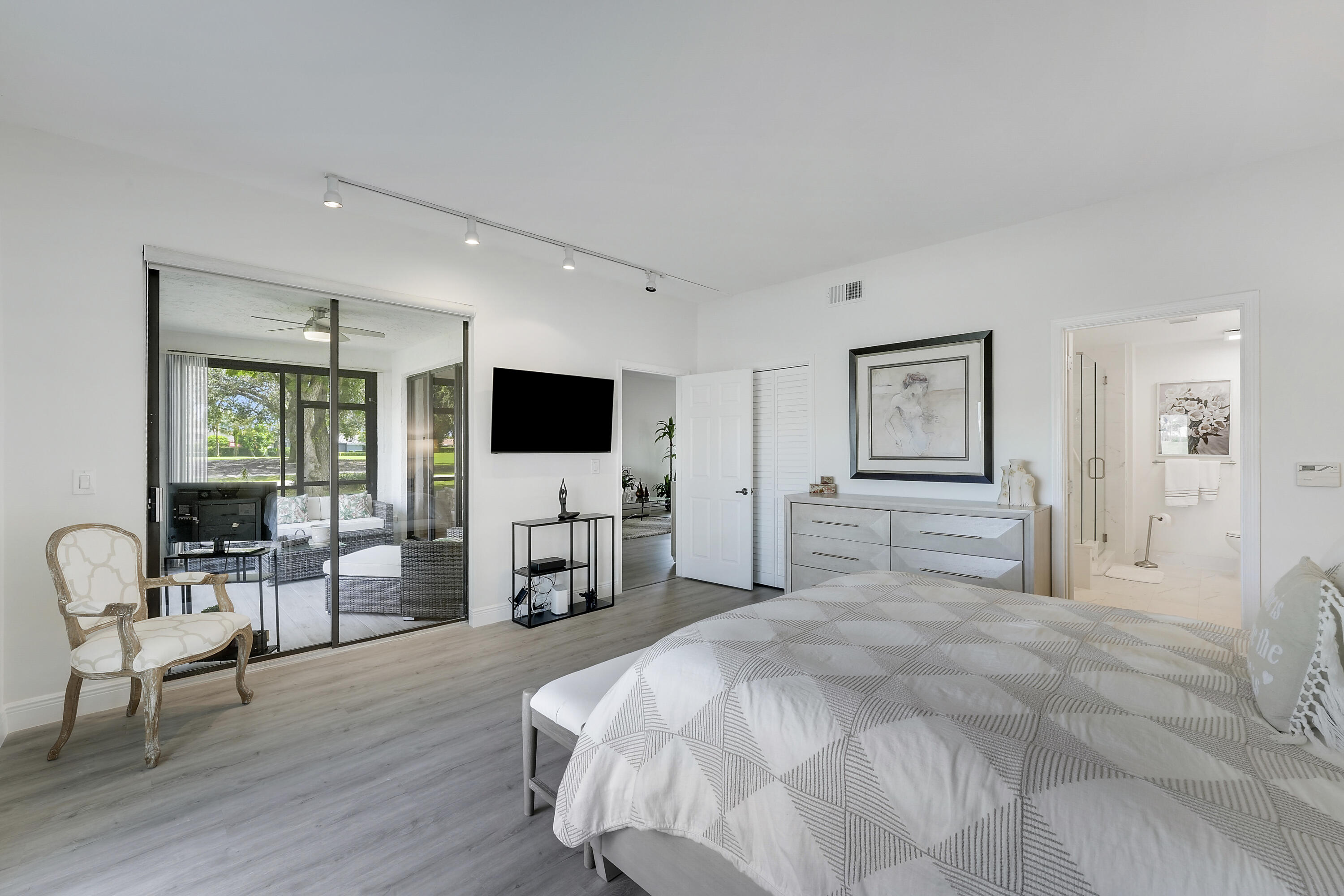 7860 Seville Place, Unit 2203 Boca Raton, FL 33433 - Photo 20 of 43 a bedroom with a bed and a flat screen tv