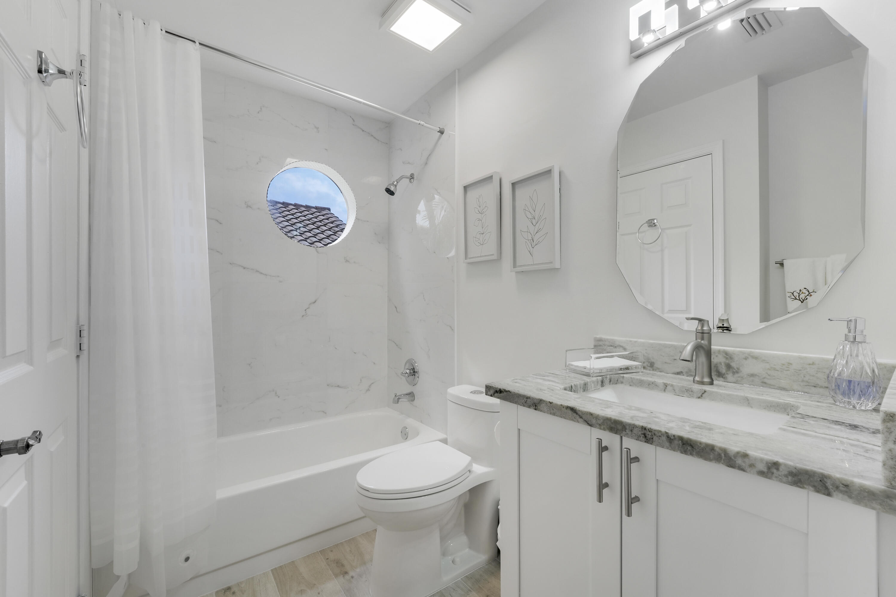 7860 Seville Place, Unit 2203 Boca Raton, FL 33433 - Photo 25 of 43 a bathroom with a granite countertop sink a toilet and shower