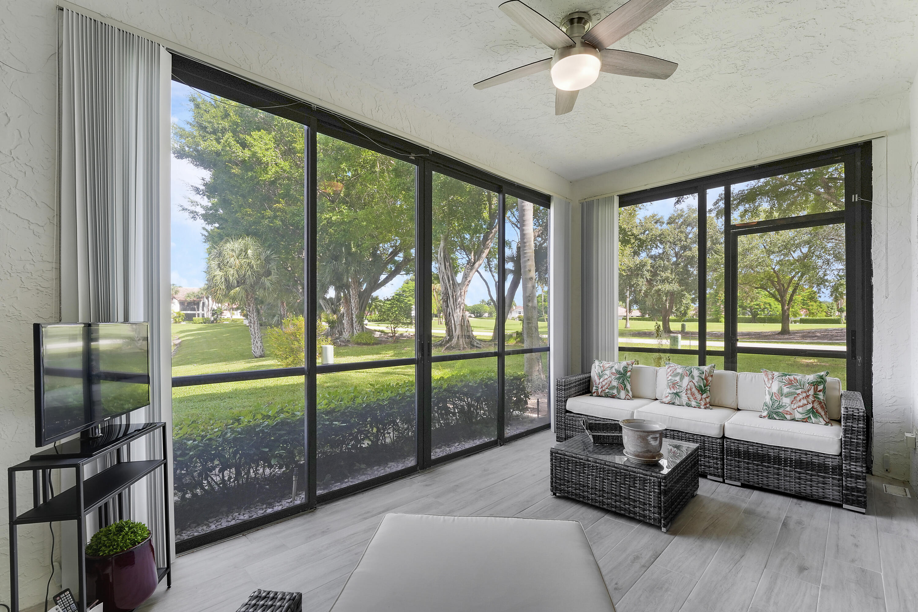 7860 Seville Place, Unit 2203 Boca Raton, FL 33433 - Photo 28 of 43 a living room with furniture and a floor to ceiling window