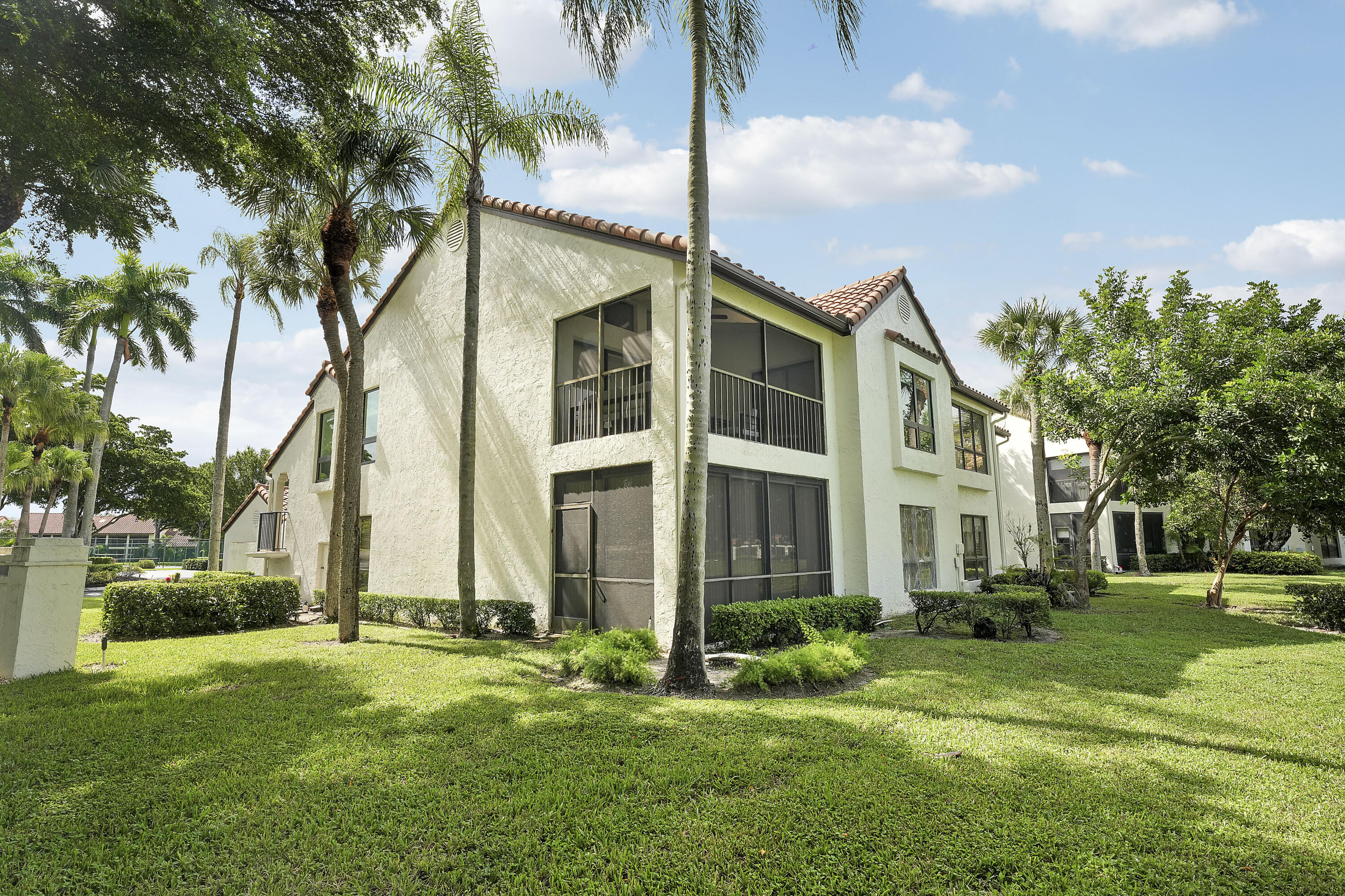7860 Seville Place, Unit 2203 Boca Raton, FL 33433 - Photo 31 of 43 a view of a white building among the yard